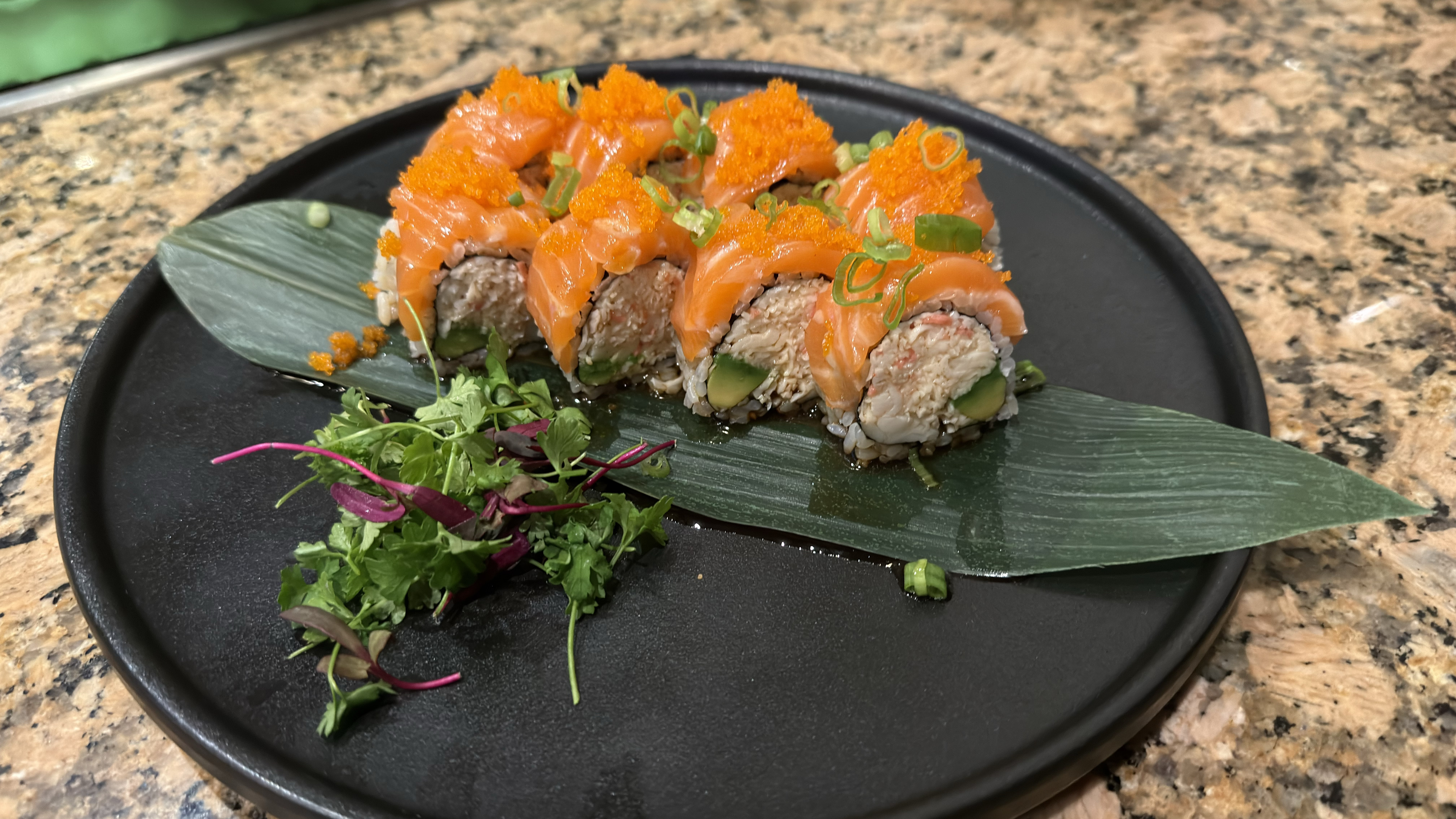 Salmon tobiko roll on bamboo leaf